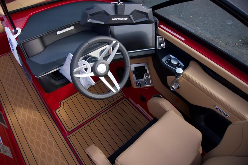 Slide: The Image of 2025 MasterCraft XT22T boat interior with modern dashboard and tan seating. - 9