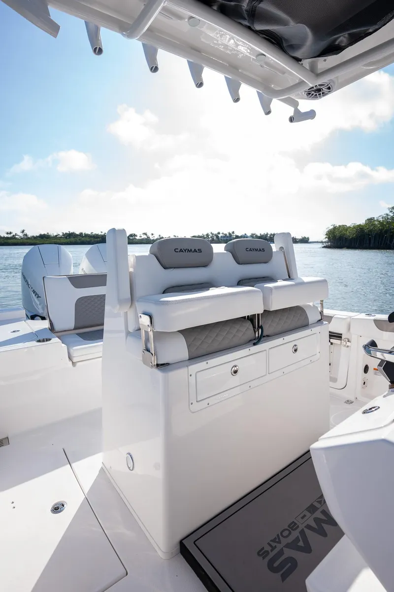 Slide: The Image of 2025 Caymas 291 boat interior with cushioned seating, sleek design, and scenic water view. - 12