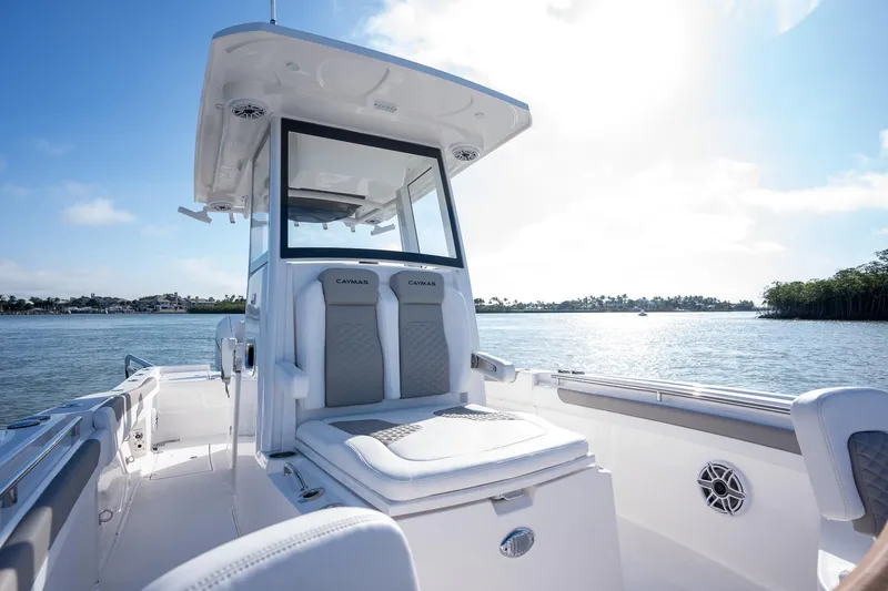 Slide: The Image of 2025 Caymas 291 boat interior on a sunny day, featuring sleek seating and modern design. - 14