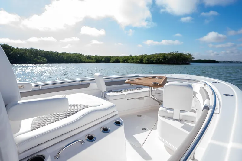 Slide: The Image of Luxurious 2025 Caymas 291 boat interior with seating, table, and scenic water view. - 17