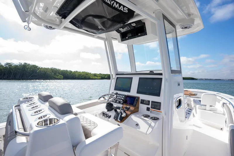 Slide: The Image of 2025 Caymas 291 boat interior with modern controls, on a sunny day by the water. - 19