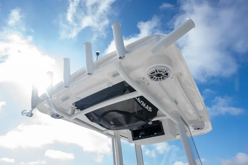 Slide: The Image of 2025 Caymas 291 boat top with rod holders against a bright sky. - 20