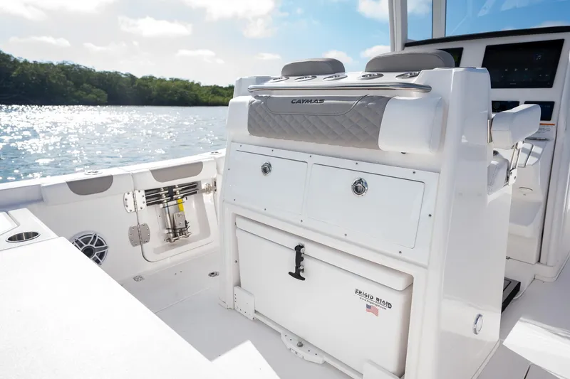 Slide: The Image of 2025 Caymas 291 boat interior with storage compartments, on a sunny day by the water. - 21