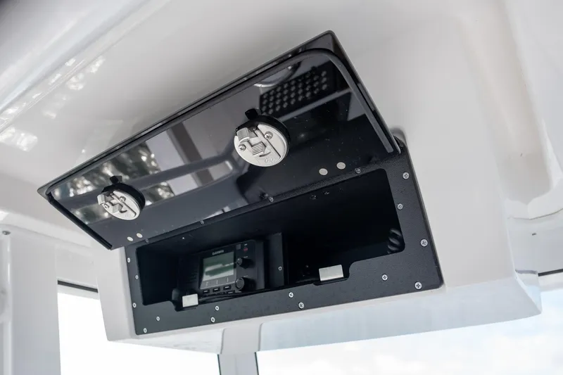 Slide: The Image of 2025 Caymas 291 boat console with storage compartment and electronic equipment. - 28