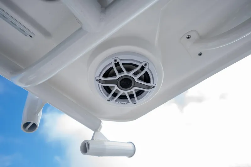 Slide: The Image of 2025 Caymas 291 boat speaker and rod holders against blue sky. - 29