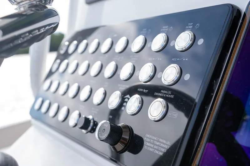 Slide: The Image of Control panel of 2025 Caymas 291 boat with multiple buttons and knobs. - 30