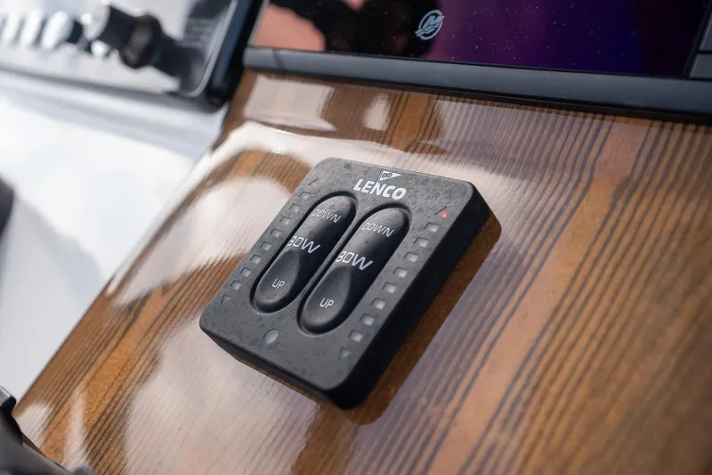 Slide: The Image of Close-up of Lenco control panel on 2025 Caymas 291 boat dashboard. - 31