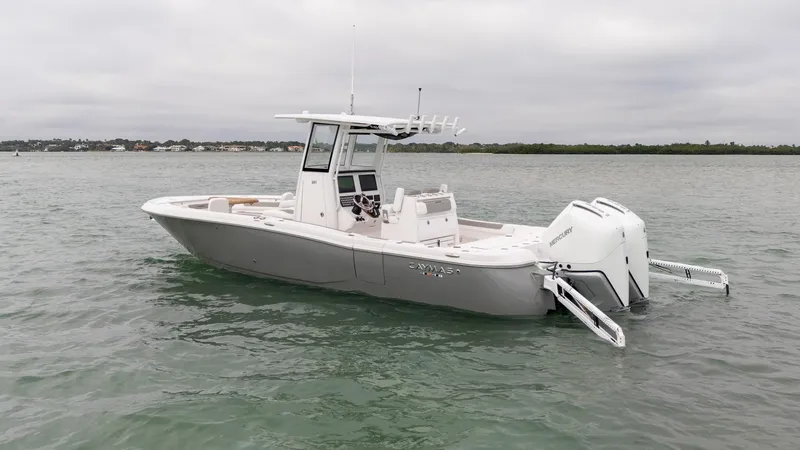 Slide: The Image of 2025 Caymas 291 boat on water, featuring sleek design and dual outboard engines. - 4
