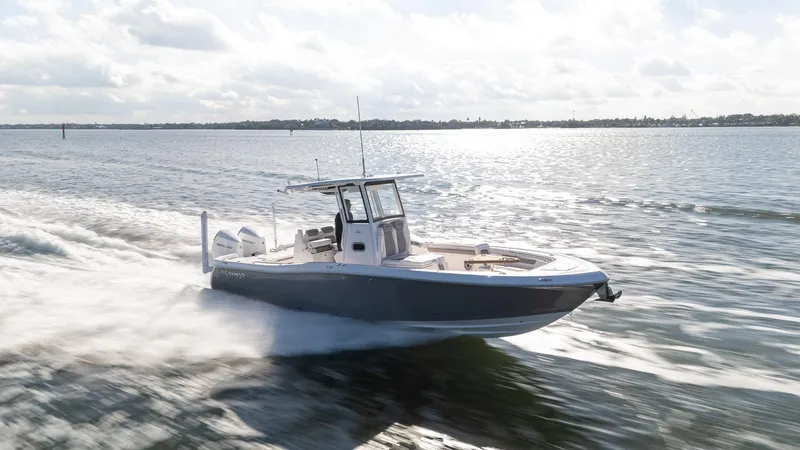 Slide: The Image of 2025 Caymas 291 boat speeding on open water under a cloudy sky. - 7