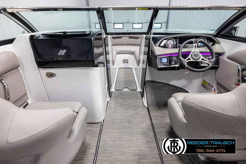 Slide: The Image of 2025 Four Winns HD5 boat interior with modern dashboard and seating, showcased by Reeder-Trausch Marine. - 15