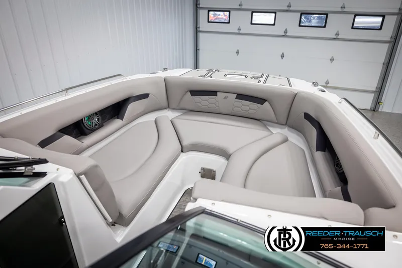 Slide: The Image of 2025 Four Winns HD5 boat interior with luxurious seating in a showroom. - 20