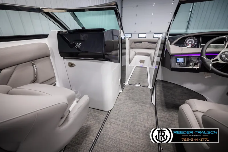 Slide: The Image of Interior of 2025 Four Winns HD5 boat, featuring modern seating and dashboard design. - 25