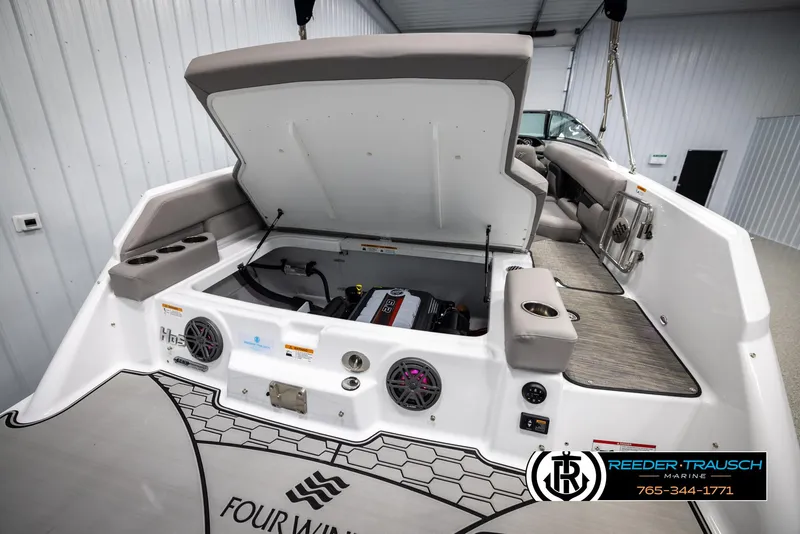 Slide: The Image of 2025 Four Winns HD5 boat engine compartment with open hatch, showcasing interior features and design. - 33