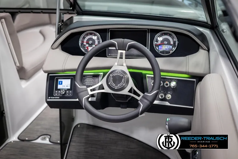 Slide: The Image of 2025 Four Winns HD5 boat dashboard with steering wheel and control panel. - 34