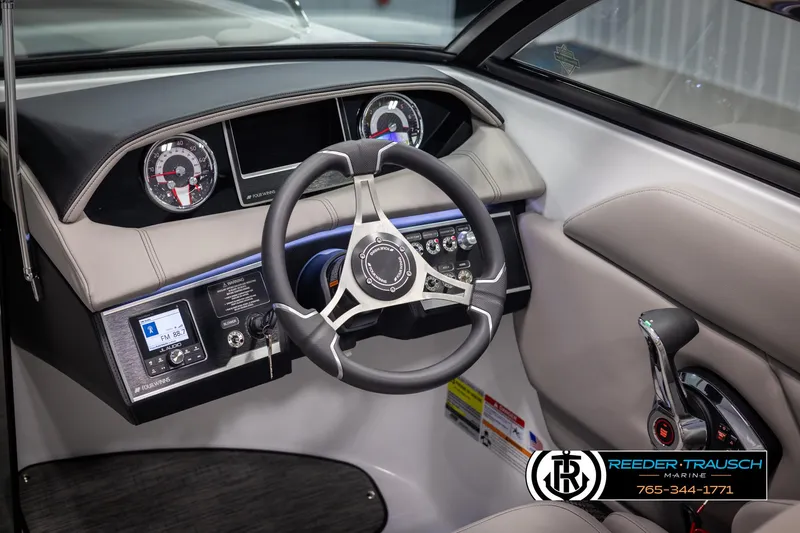 Slide: The Image of 2025 Four Winns HD5 boat dashboard with steering wheel and control panel. - 35