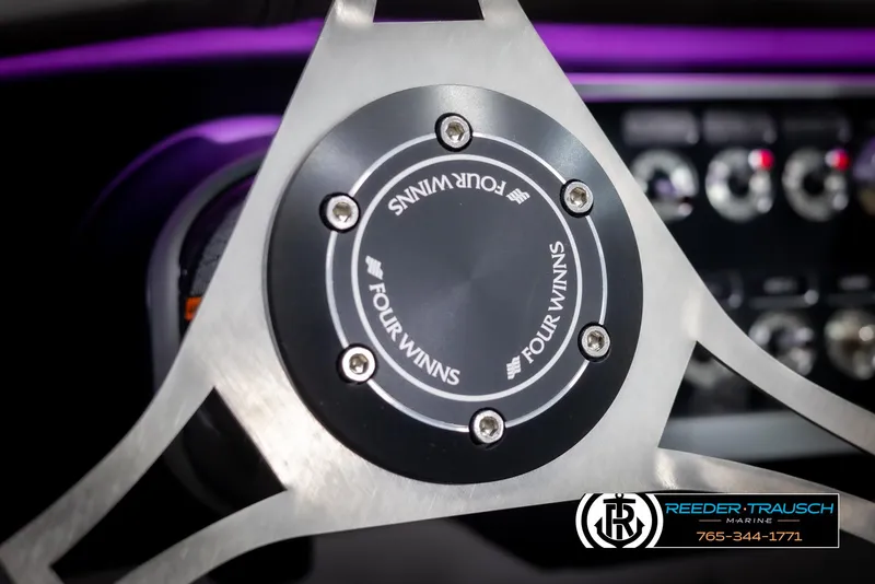 Slide: The Image of Steering wheel of 2025 Four Winns HD5 boat with Reeder-Trausch Marine logo. - 36