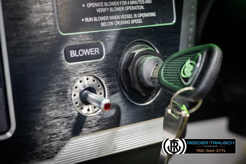 Slide: The Image of 2025 Four Winns HD5 boat ignition with key and blower switch. - 38