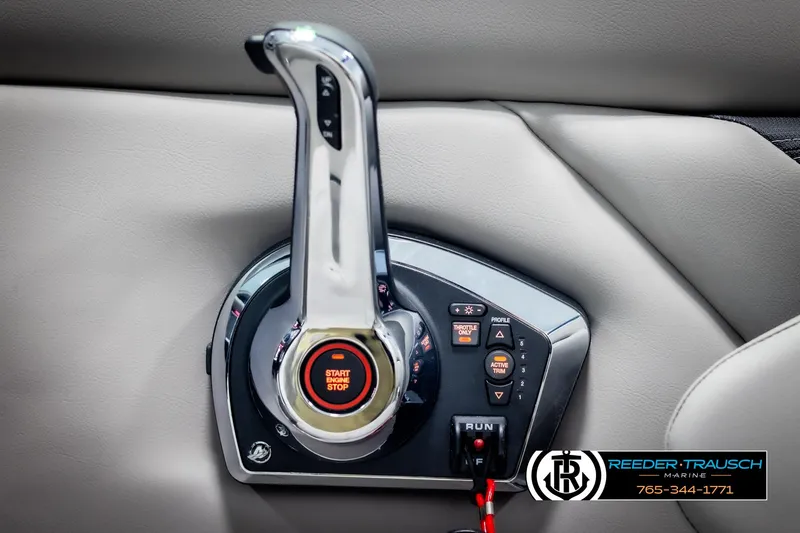 Slide: The Image of 2025 Four Winns HD5 boat throttle control with start/stop button and trim settings. - 42