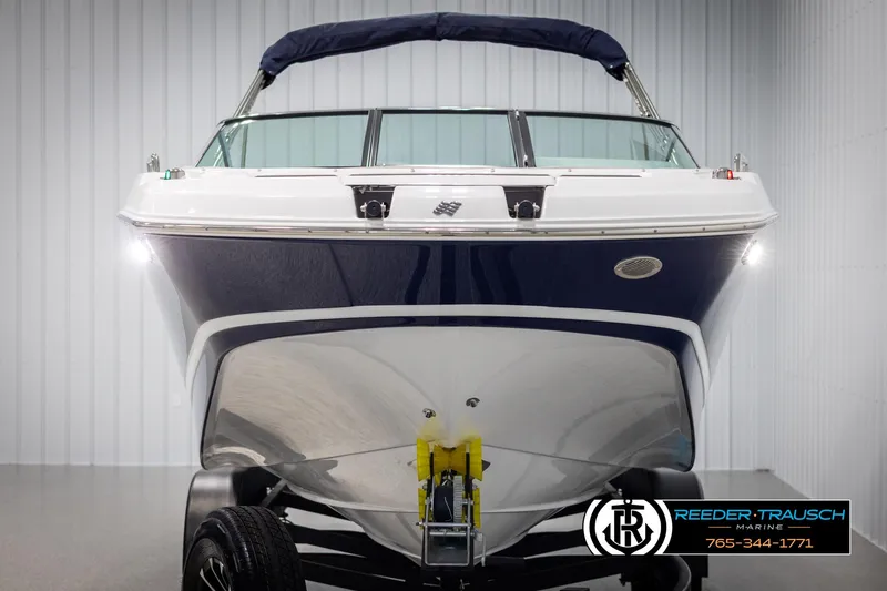 Slide: The Image of 2025 Four Winns HD5 boat in showroom, front view with trailer. - 8