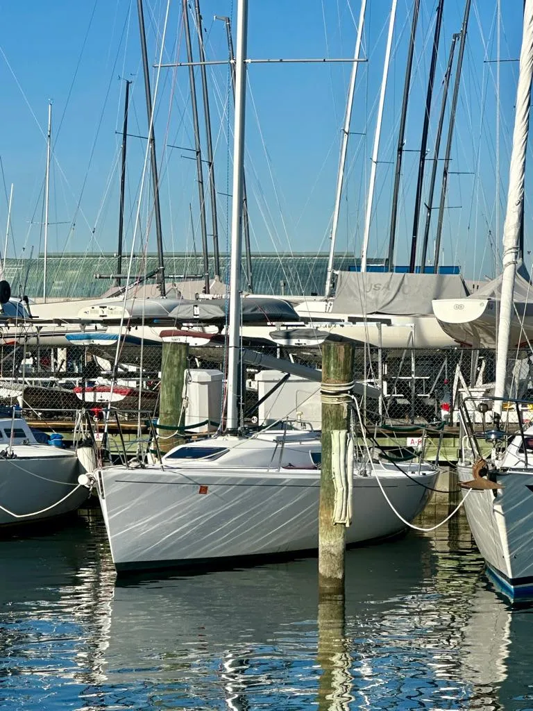 Slide: The Image of 2006 J Boats J/92S sailboat docked in a marina with clear blue skies. - 2