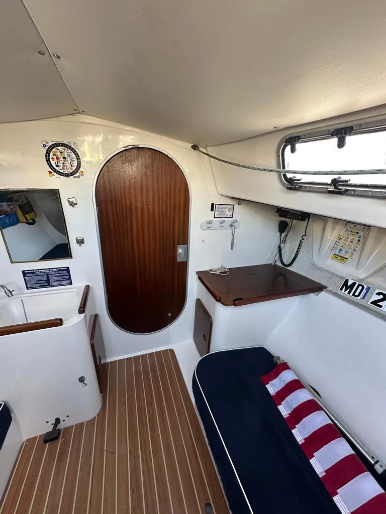Slide: The Image of Interior of 2006 J Boats J/92S sailboat with wood accents and seating area. - 29