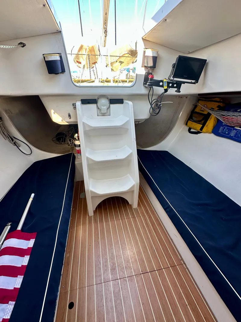 Slide: The Image of Interior of 2006 J Boats J/92S sailboat with wooden flooring and blue seating. - 36