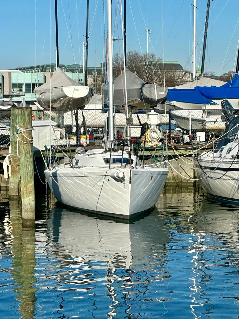 Slide: The Image of 2006 J Boats J/92S sailboat docked in a marina, reflecting on calm water. - 4