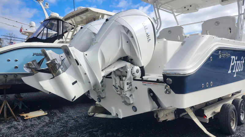 Slide: The Image of Edgewater 280 CX 2023 boat with Yamaha outboard engines on a trailer. - 10