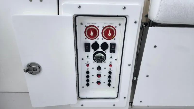 Slide: The Image of Control panel of 2023 Edgewater 280 CX boat with switches and dials. - 18