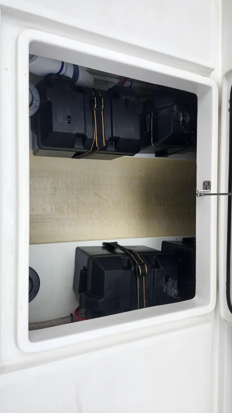 Slide: The Image of Edgewater 280 CX 2023 boat storage compartment with secured equipment. - 26