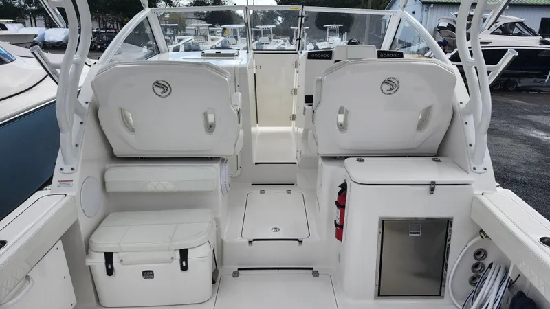 Slide: The Image of 2023 Edgewater 280 CX boat interior with seating and storage compartments. - 28