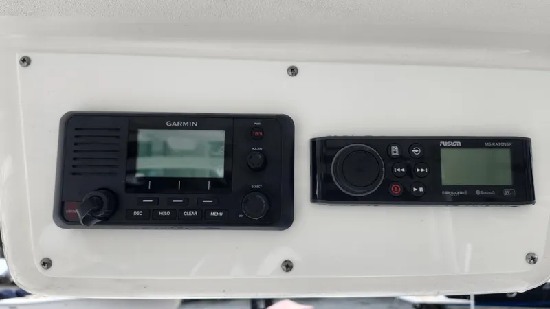 Slide: The Image of Garmin and Fusion marine electronics on 2023 Edgewater 280 CX boat dashboard. - 31