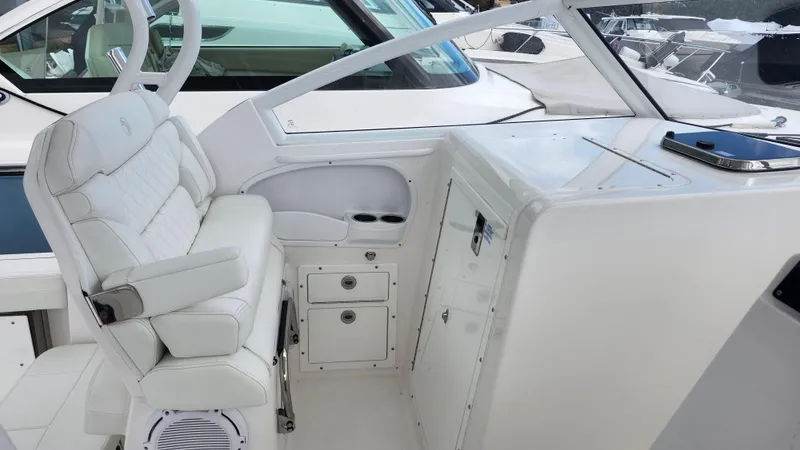 Slide: The Image of 2023 Edgewater 280 CX boat interior with white seating and storage compartments. - 32