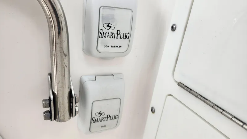 Slide: The Image of SmartPlug outlets on 2023 Edgewater 280 CX boat, featuring stainless steel handle. - 35