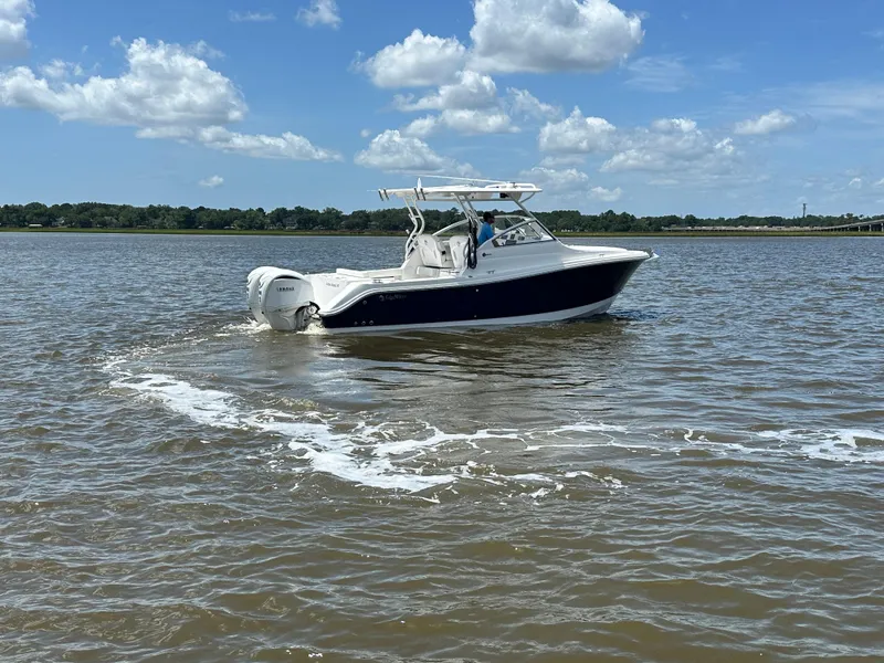 Slide: The Image of 2023 Edgewater 280 CX boat cruising on a sunny day with clear skies. - 4