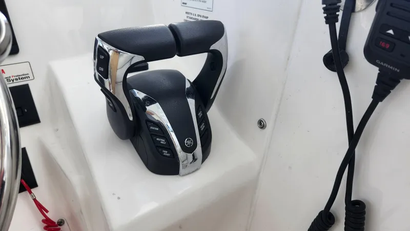 Slide: The Image of Edgewater 280 CX 2023 boat throttle controls and communication equipment. - 41