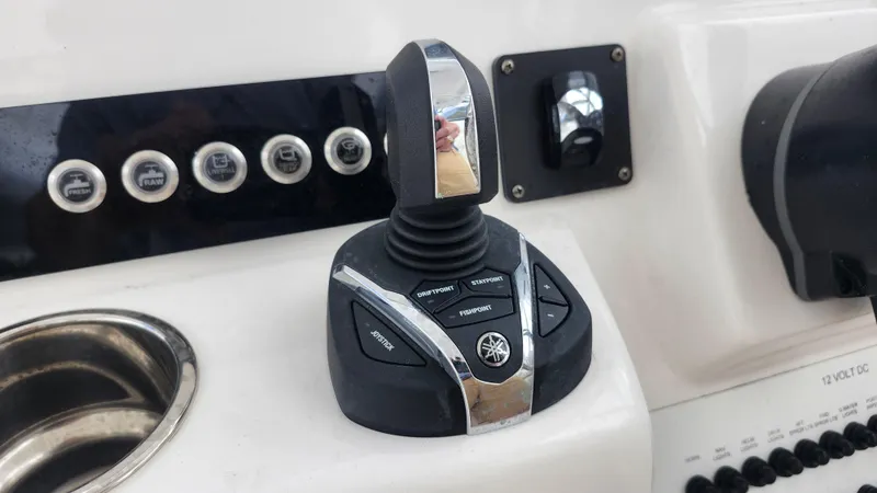 Slide: The Image of Edgewater 280 CX 2023 boat control panel with joystick and buttons. - 42