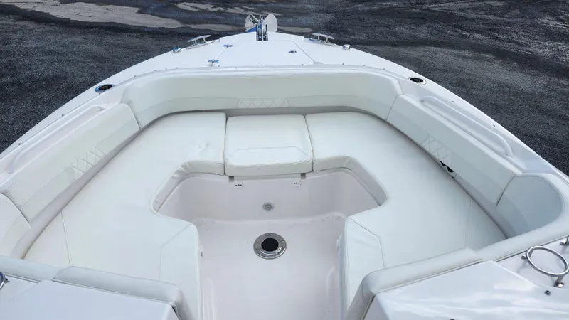 Slide: The Image of 2023 Edgewater 280 CX boat with spacious white seating area. - 47