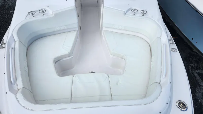 Slide: The Image of 2023 Edgewater 280 CX boat with spacious white seating area. - 49