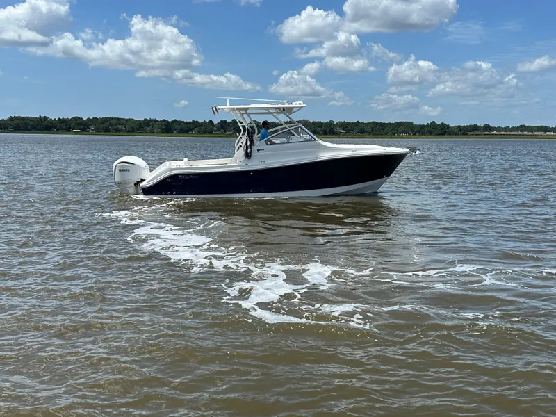 Slide: The Image of 2023 Edgewater 280 CX boat cruising on a sunny day with clear skies. - 5