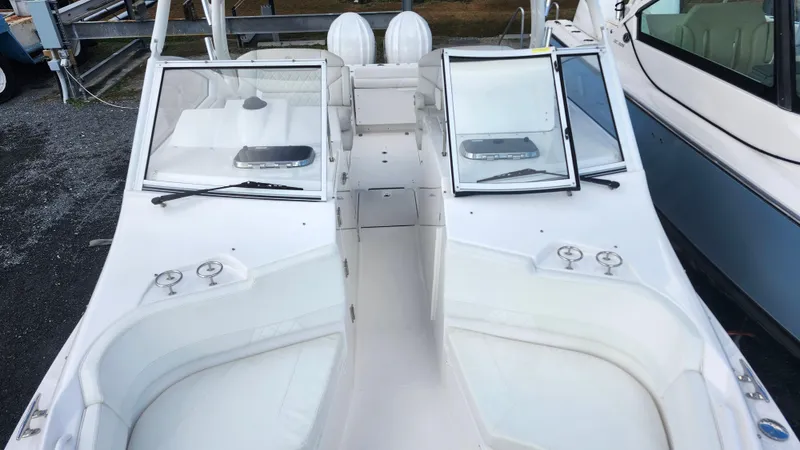 Slide: The Image of 2023 Edgewater 280 CX boat interior with open windshield and seating. - 53