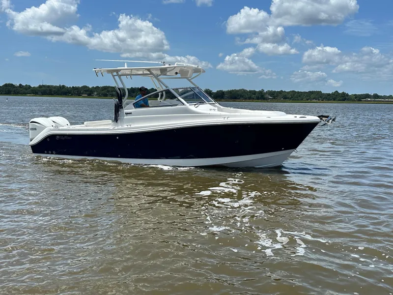 Slide: The Image of 2023 Edgewater 280 CX boat cruising on a sunny day with clear skies. - 6