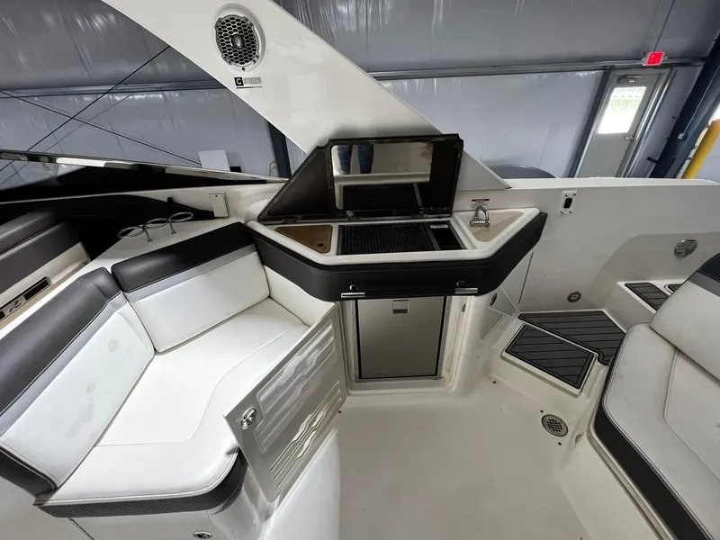 Slide: The Image of Interior of a 2016 Sea Ray 310 SLX boat with seating and kitchenette. - 11