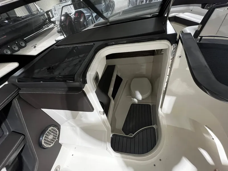 Slide: The Image of Interior view of 2016 Sea Ray 310 SLX boat cabin with compact toilet. - 12