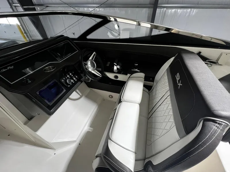 Slide: The Image of Interior of 2016 Sea Ray 310 SLX boat, featuring sleek dashboard and comfortable seating. - 14