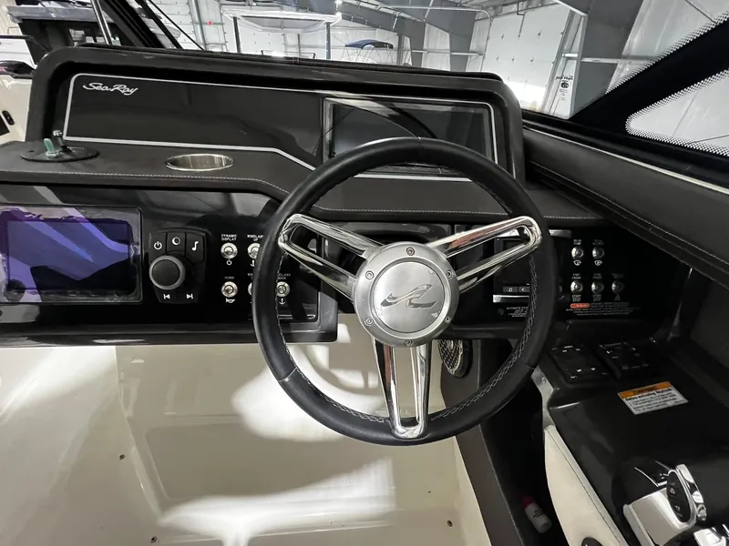 Slide: The Image of Steering wheel and dashboard of a 2016 Sea Ray 310 SLX boat. - 15