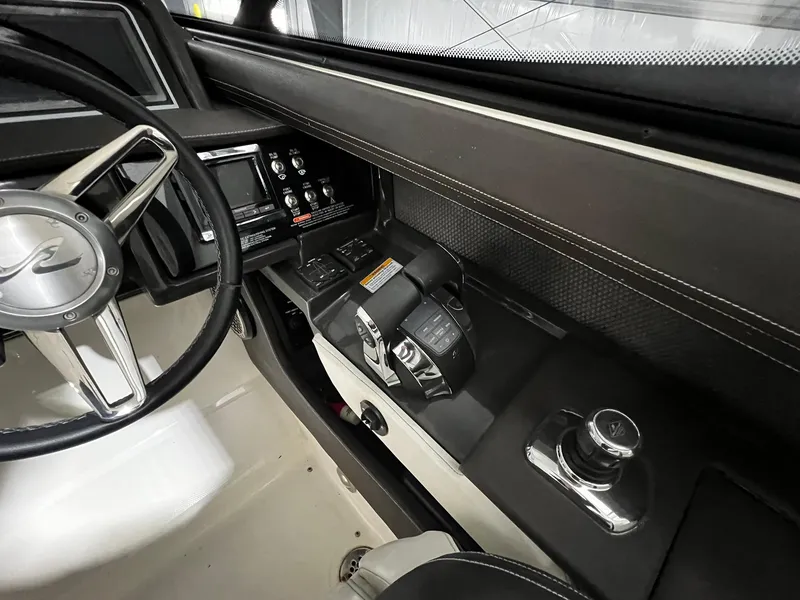 Slide: The Image of Interior cockpit of 2016 Sea Ray 310 SLX boat, featuring steering wheel and control panel. - 16