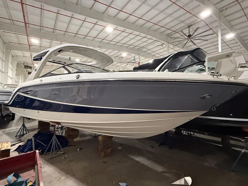 Slide: The Image of 2016 Sea Ray 310 SLX boat in indoor storage facility. - 2