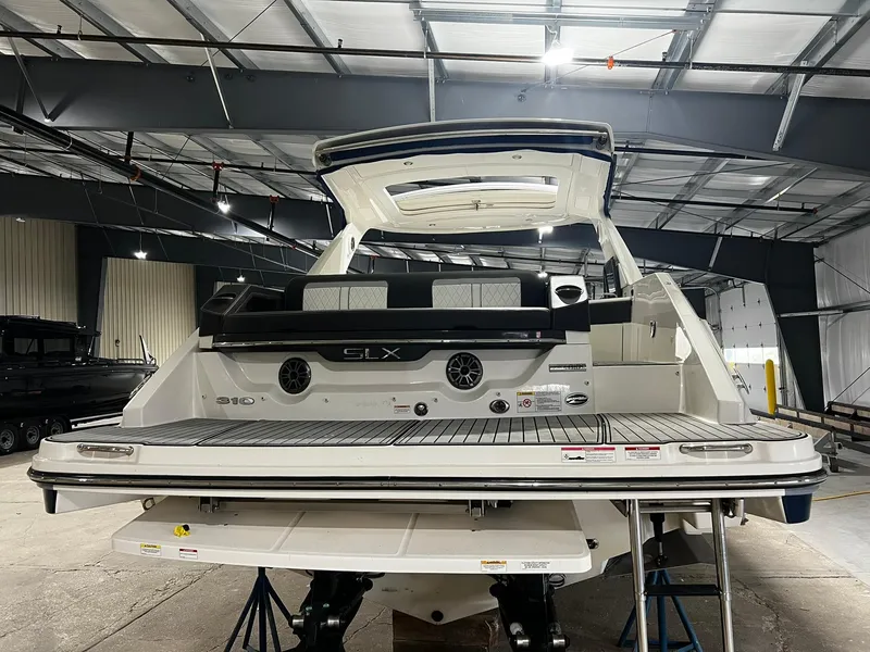 Slide: The Image of 2016 Sea Ray 310 SLX boat in a warehouse, rear view. - 6