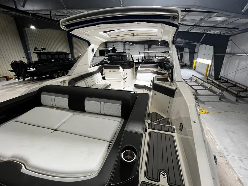 Slide: The Image of 2016 Sea Ray 310 SLX boat interior with spacious seating in a storage facility. - 8
